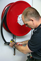 Inspector checking fire hose reel